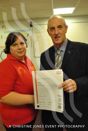 Angela Broomfield receives her City and Guilds certificate from M&O Training managing director Paul Organ