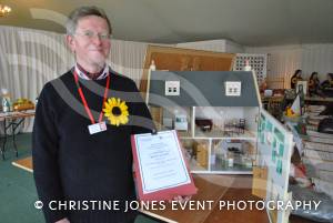 Hospice supporter Godfrey Davey at Wincanton Racecourse on October 28, 2012, with a dolls house donated by Sue and Brian Church for a charity silent auction.