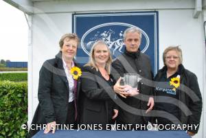 Canadian Diamond trainer Brendan Powell receives his prize for winning the St Margaret's Hospice Handicap Hurdle from St Margaret's Carol Taylor, Jill Philips and Gill Kirkpatrick.