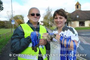 Ilminster Lions' Pete Marshall and Olympic torchbearer Tonia White with medals at the finishing line of the Ilminster Lions 10k on November 4, 2012