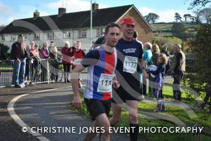 Blind athlete Mick Duplock (no 1127) nears the finishing line with his support runner.